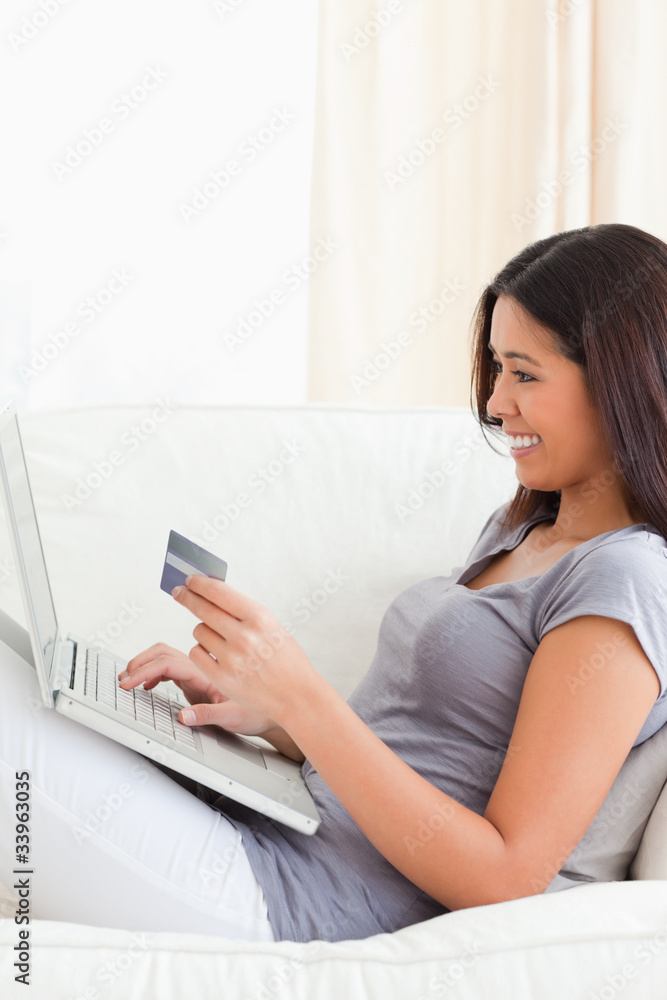 smiling woman working with notebook holding card smiling woman working with notebook holding card