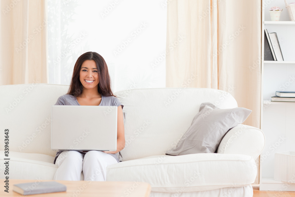 youg woman with notebook on a sofa youg woman with notebook on a sofa
