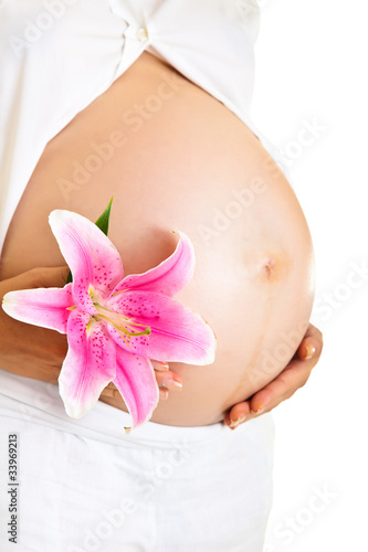 Pregnant woman holding lillies isolated on white