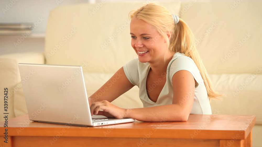 Smiling woman using her laptop Smiling woman using her laptop
