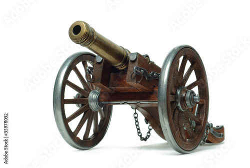 Fototapeta Ancient cannon on wheels isolated on white