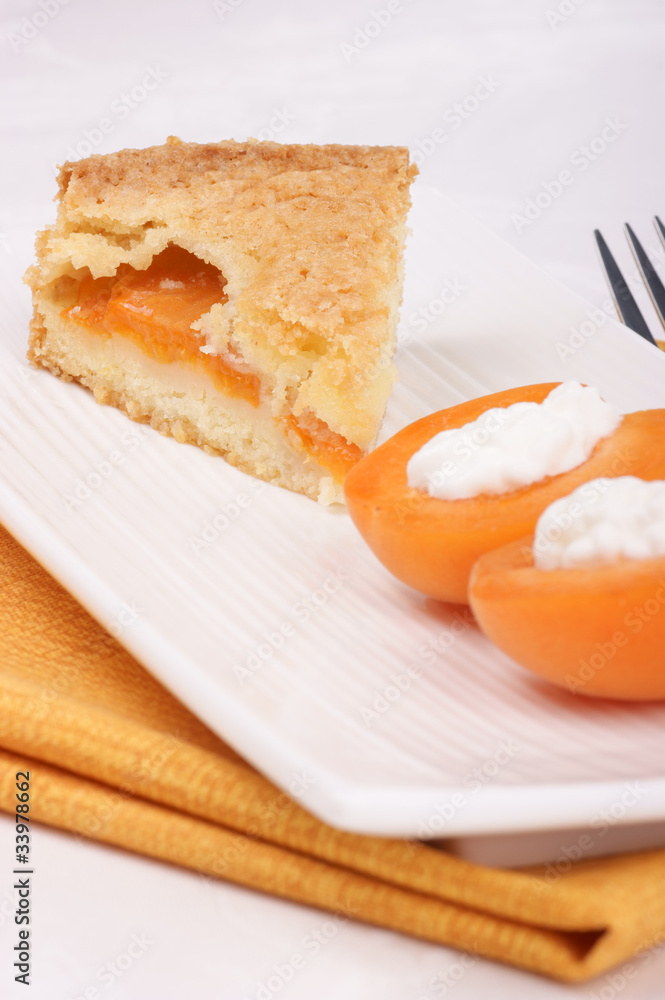 Slice of apricot tart served on a white plate Slice of apricot tart served on a white plate