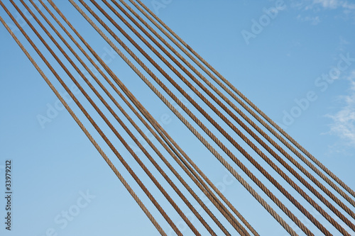 Set of steel cables against a blue sky