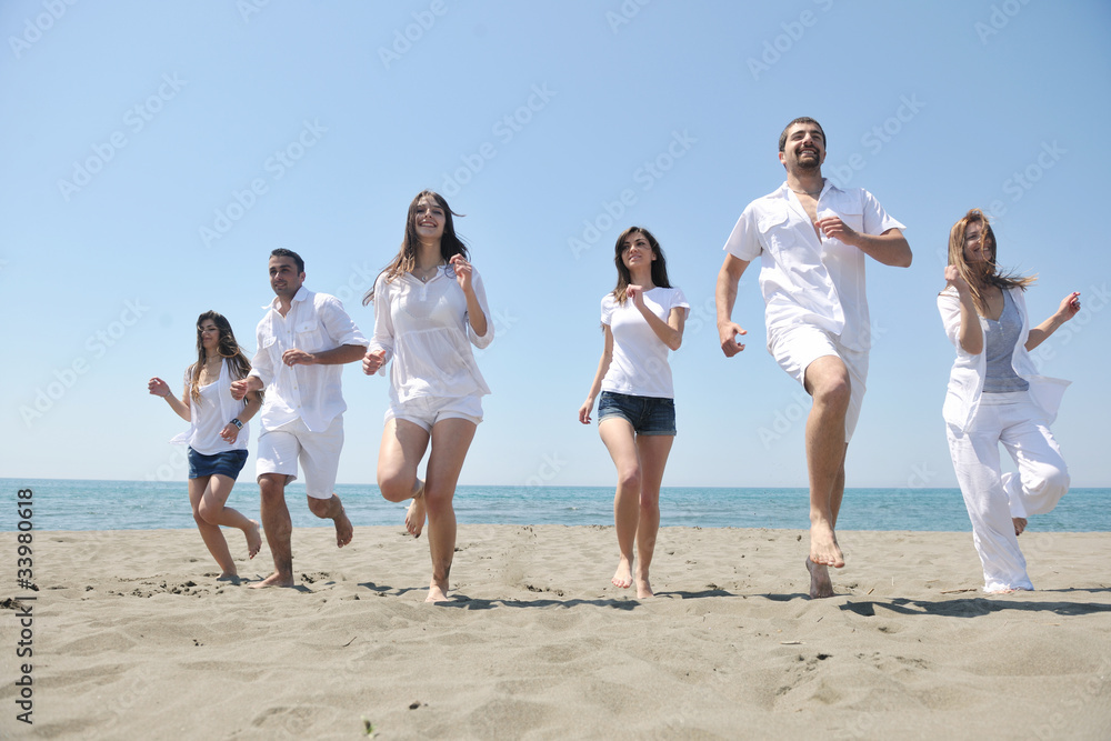 happy people group have fun and running on beach happy people group have fun and running on beach