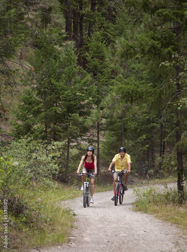Couple Cycling on Forest Trail