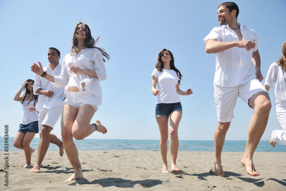 happy people group have fun and running on beach
