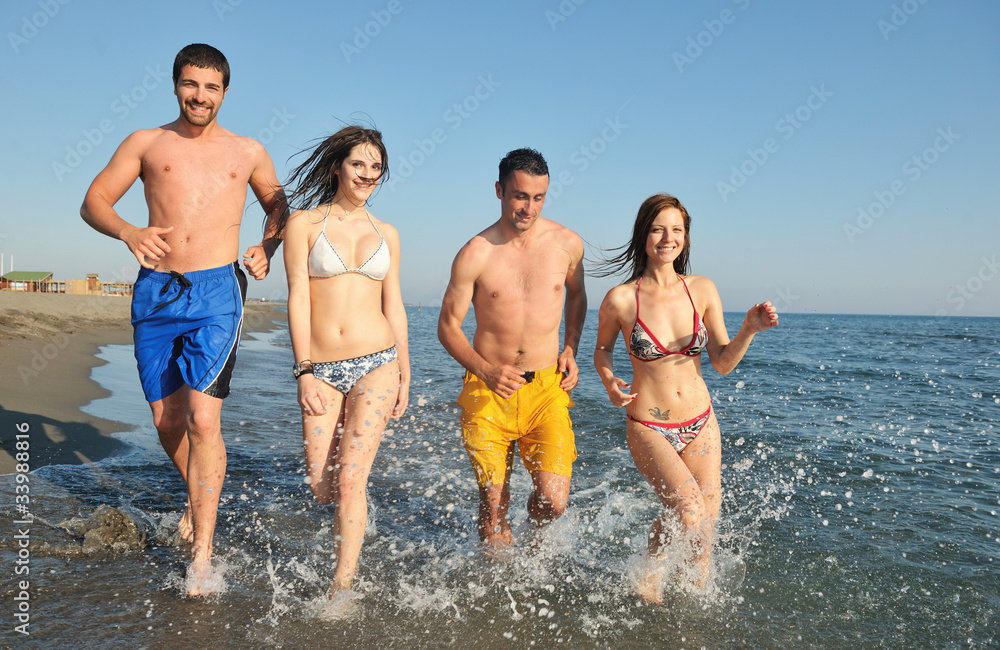 happy people group have fun and running on beach happy people group have fun and running on beach