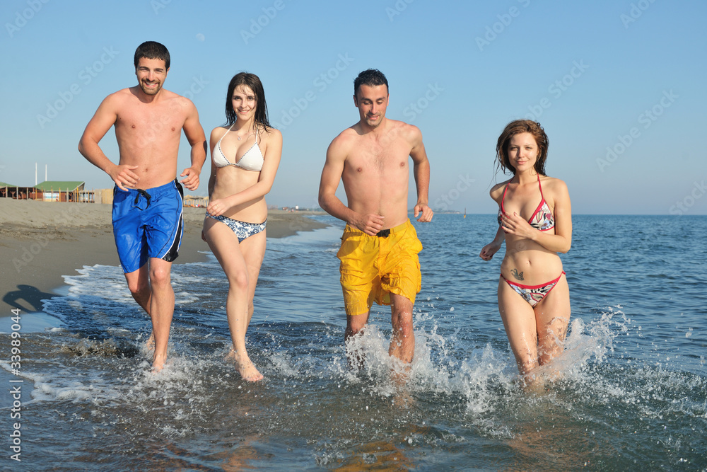 happy people group have fun and running on beach happy people group have fun and running on beach