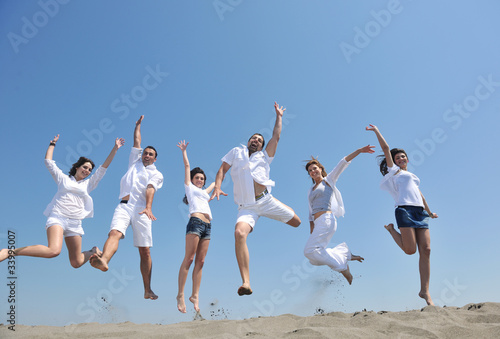 happy people group have fun and running on beach