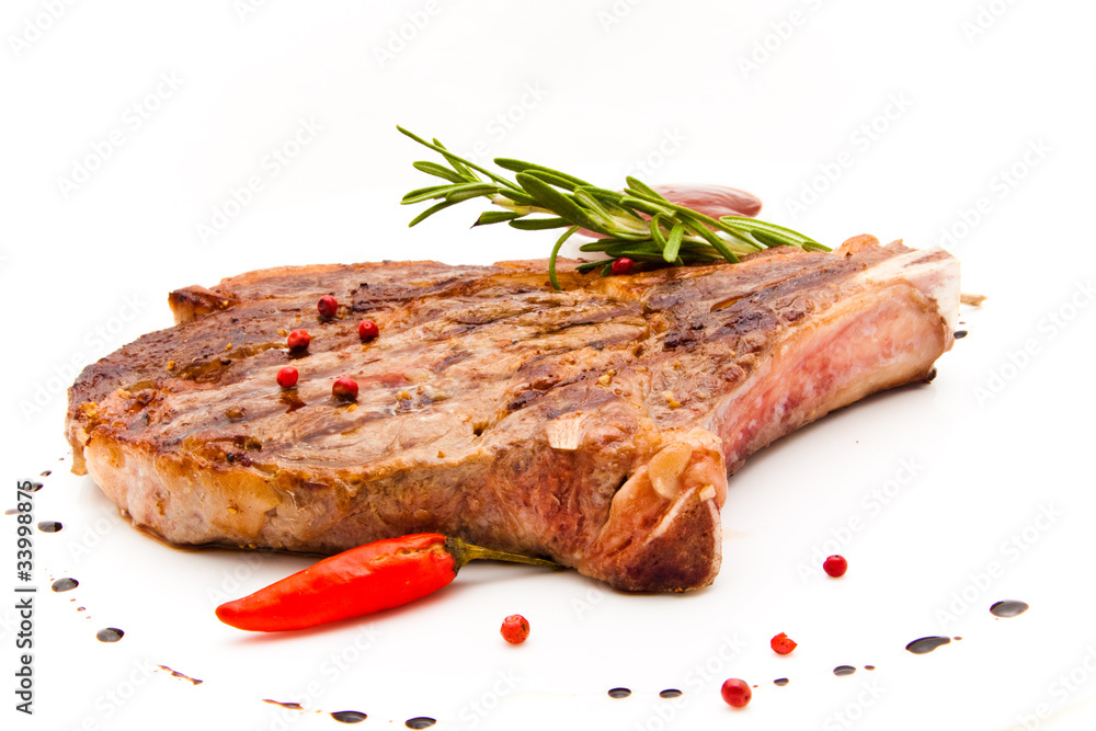 Closeup of grilled steak with peper corns and rosemary Closeup of grilled steak with peper corns and rosemary