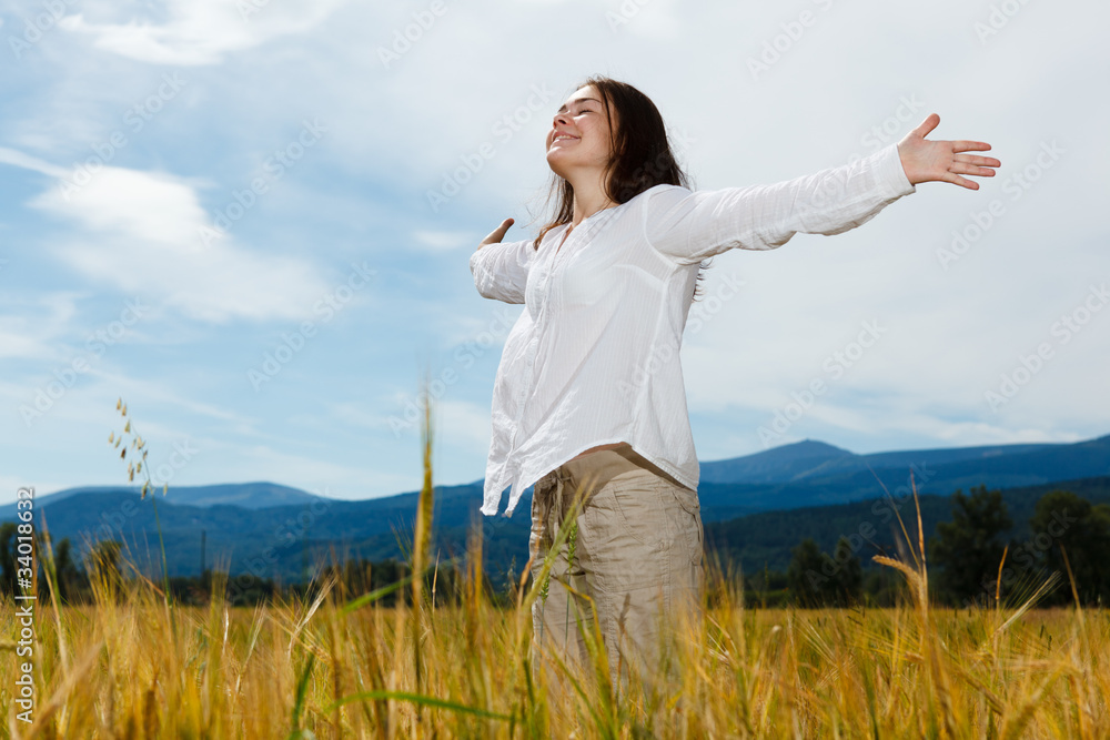 Girl holding arms up against blue sky Girl holding arms up against blue sky