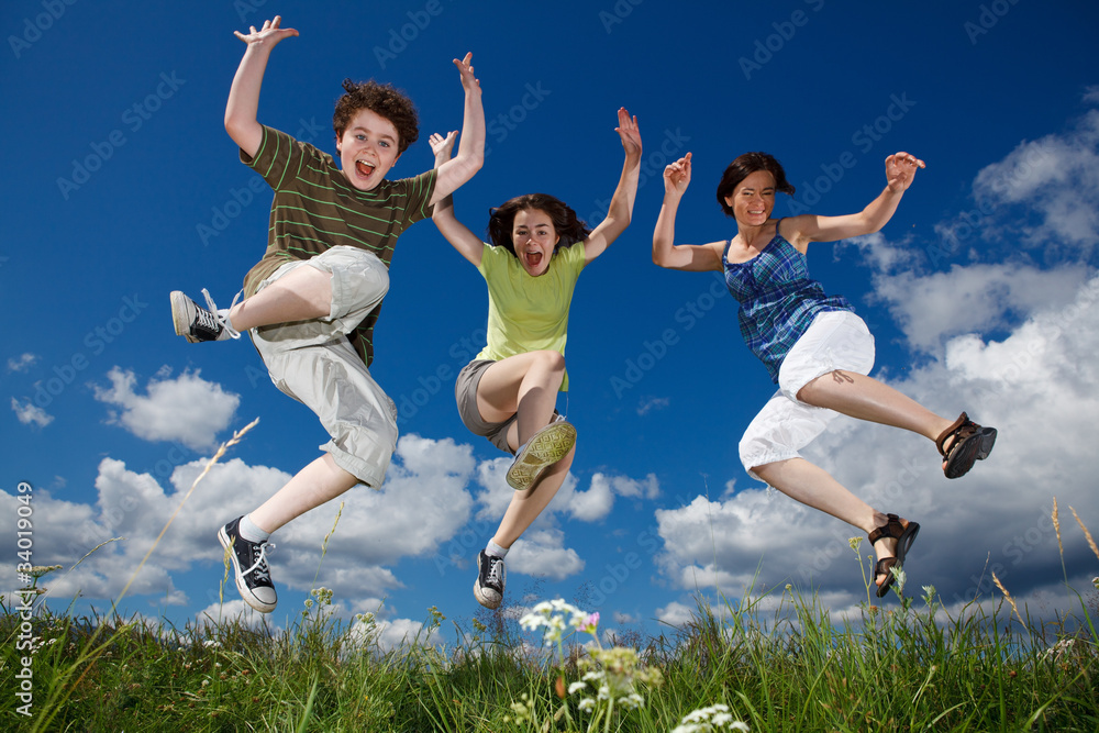 Active family - mother and kids jumping outdoor Active family - mother and kids jumping outdoor