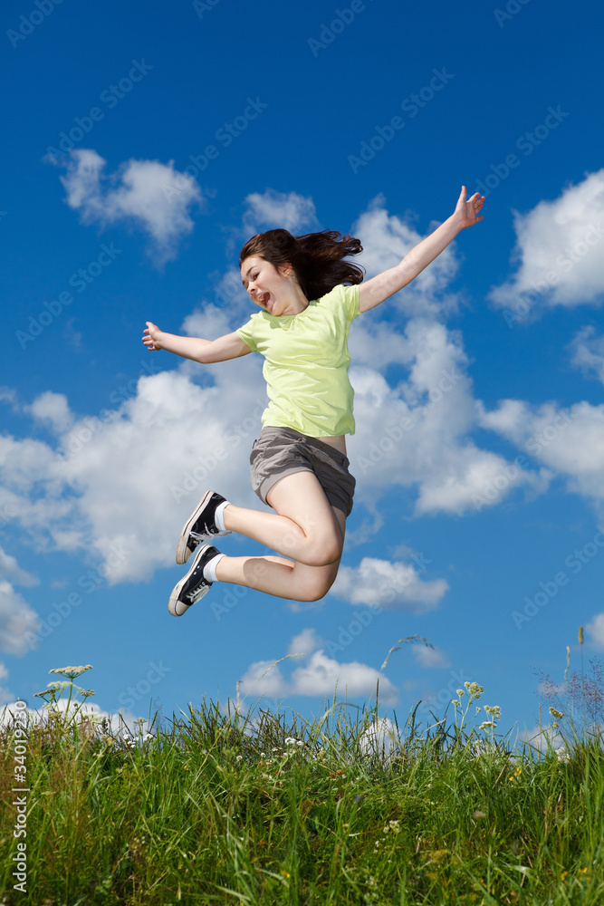 Girl jumping, running against blue sky Girl jumping, running against blue sky