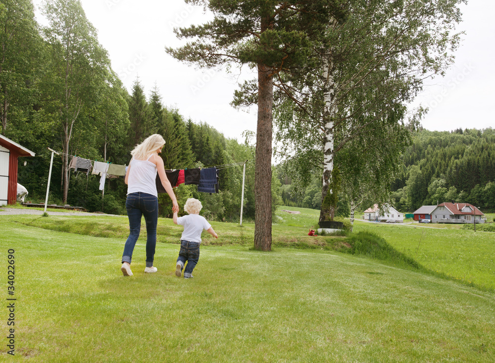 Woman and child walking in garden