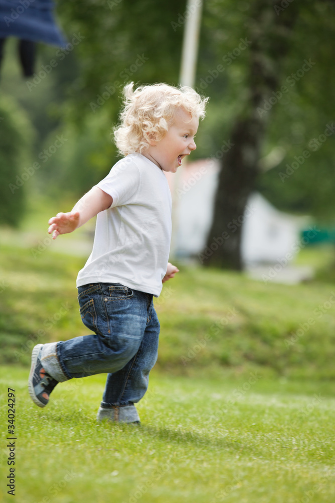 Boy running in garden Boy running in garden