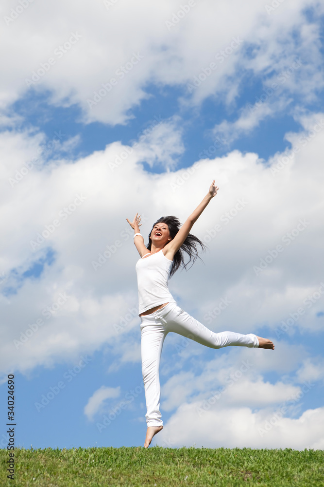 pretty young woman jumping on green grass pretty young woman jumping on green grass