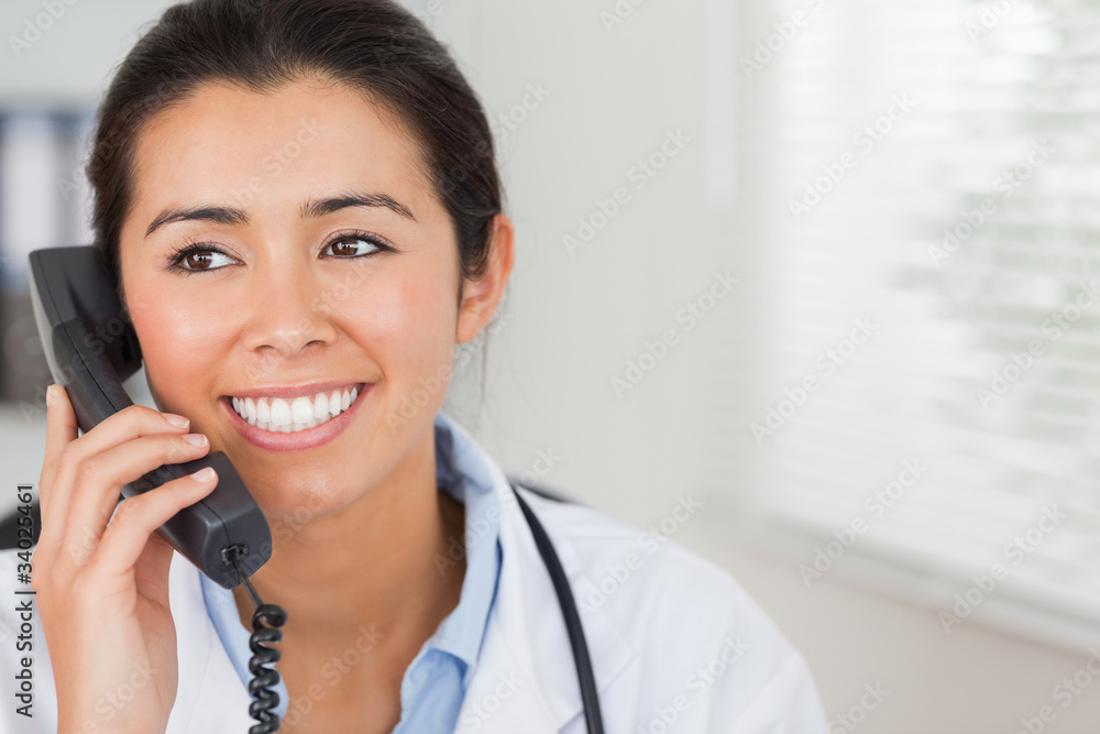 Attractive female doctor on the phone and posing Attractive female doctor on the phone and posing