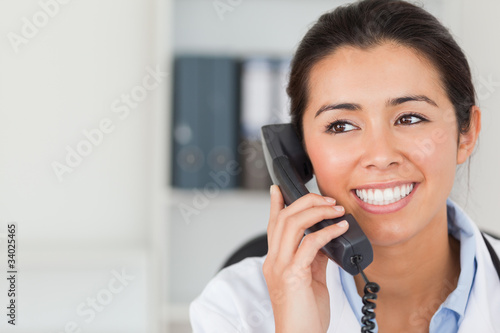 Good looking female doctor on the phone and posing © WavebreakmediaMicro