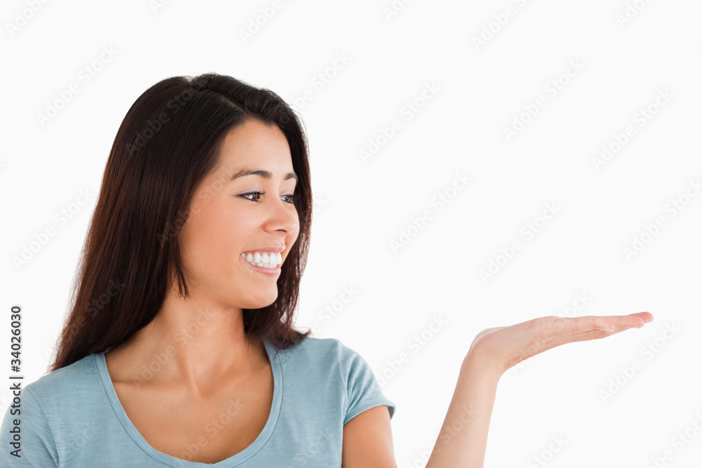 Portrait of a beautiful woman showing a copy space while standin Portrait of a beautiful woman showing a copy space while standin
