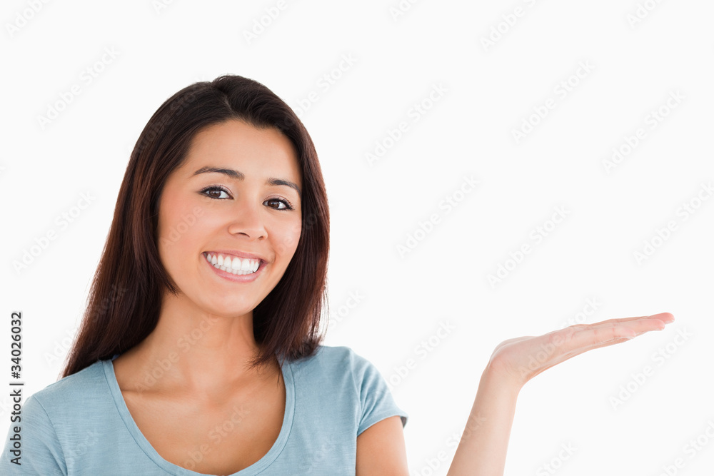 Portrait of a gorgeous woman showing a copy space while standing Portrait of a gorgeous woman showing a copy space while standing