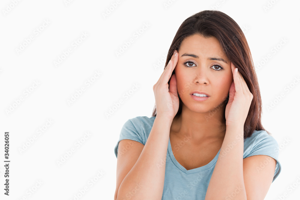 Portrait of a beautiful woman having a headache while standing Portrait of a beautiful woman having a headache while standing