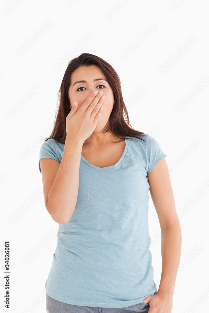 Beautiful tired woman yawning while standing Beautiful tired woman yawning while standing