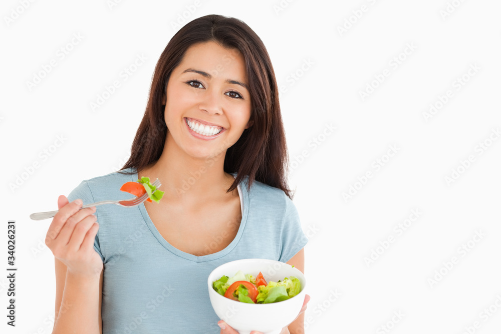 Beautiful woman eating a bowl of salad Beautiful woman eating a bowl of salad
