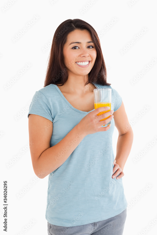 Beautiful woman holding a glass of orange juice Beautiful woman holding a glass of orange juice