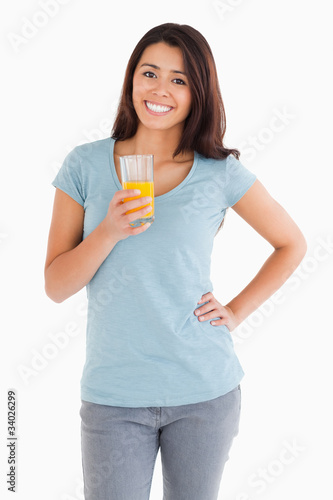 Gorgeous woman holding a glass of orange juice