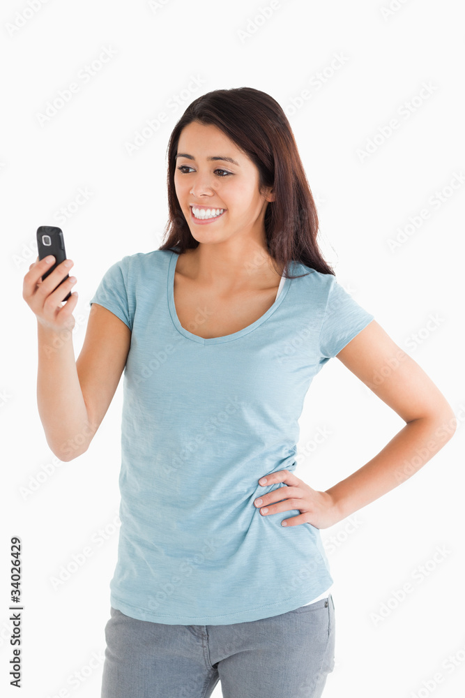 Attractive woman looking at her mobile phone Attractive woman looking at her mobile phone