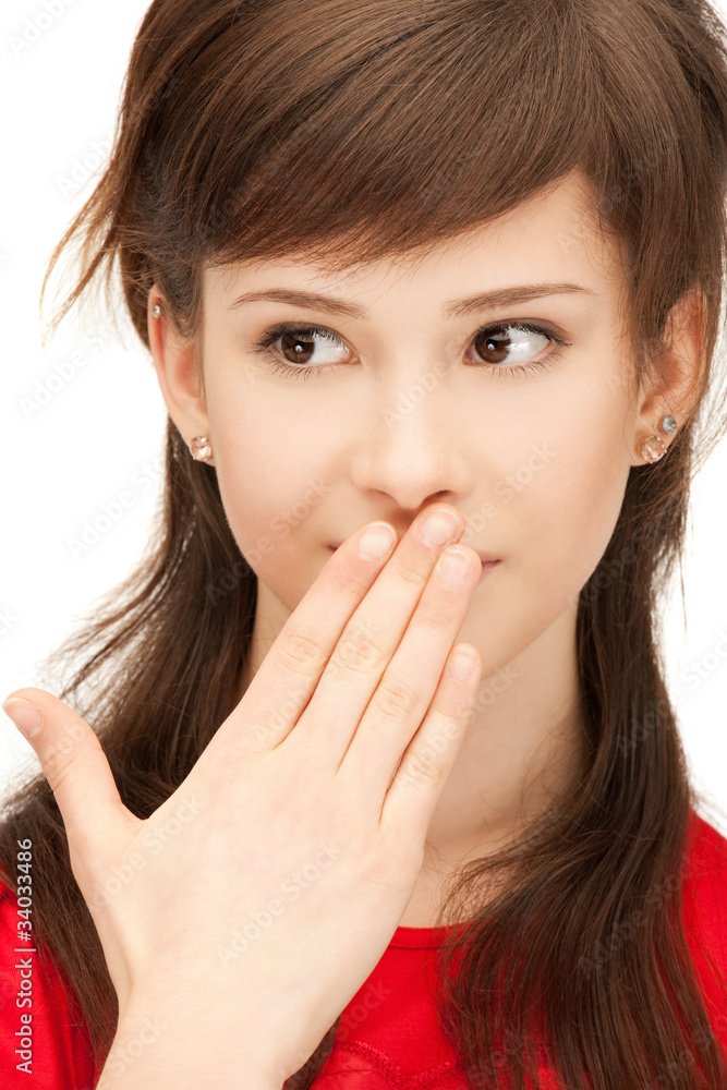 teenage girl with palms over mouth teenage girl with palms over mouth