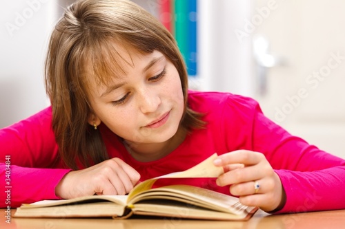 Schoolgirl reading in classroom