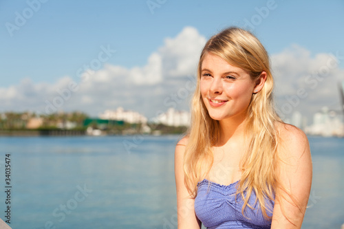 Pretty young blond woman by the bay