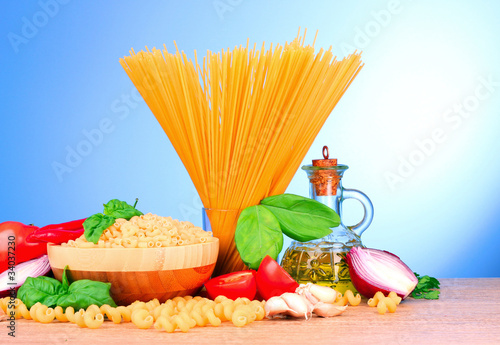spaghetti with garlic, onion, spices and basil on a yellow back