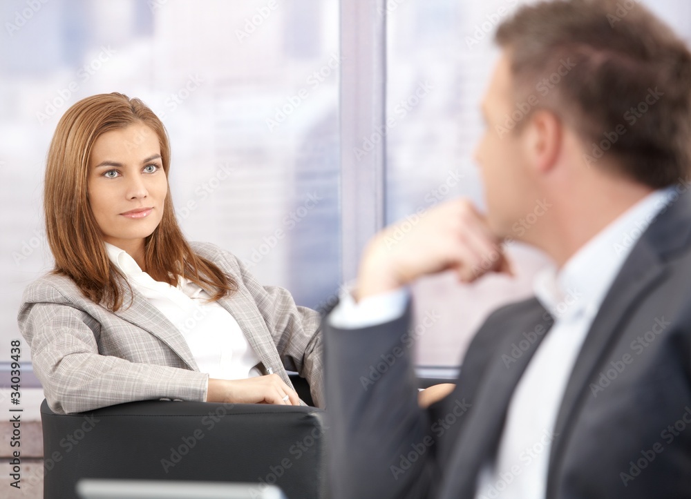 Attractive businesswoman smiling at businessman Attractive businesswoman smiling at businessman