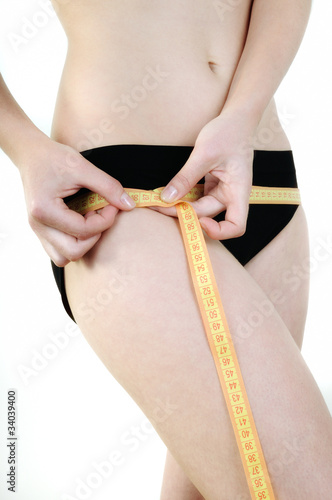 Young woman measuring the sides of the measuring tape