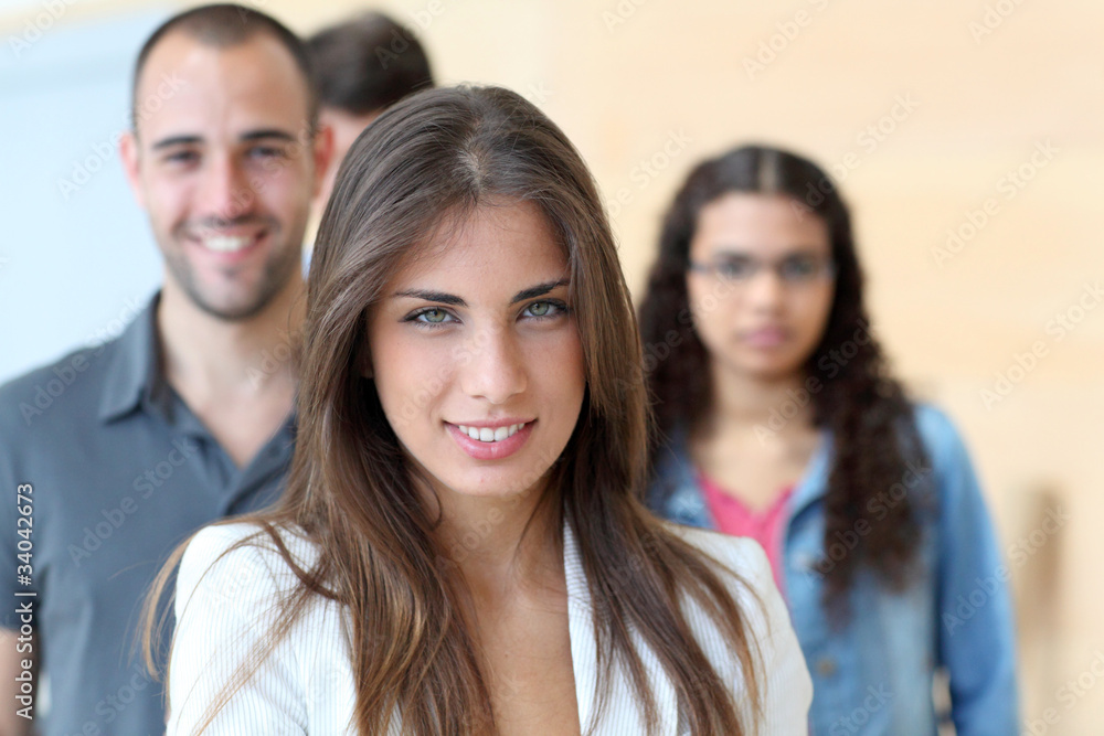 Portrait of student standing in front of group