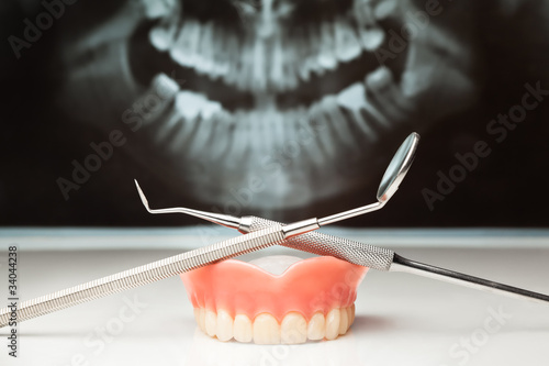 Pan x-ray, denture and dental instruments. photo