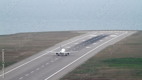 Plane takes off. Airport close to the sea.