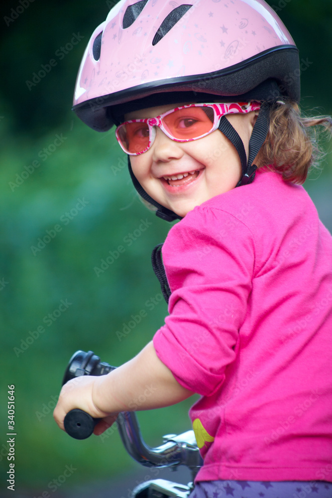 Adorable girl in pink safety helmet Adorable girl in pink safety helmet