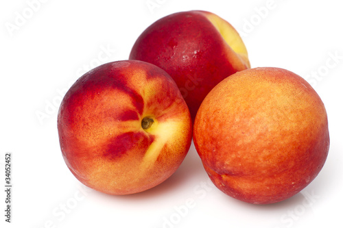 Juicy peaches isolated on white background