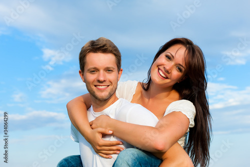 Happy couple under a blue sky