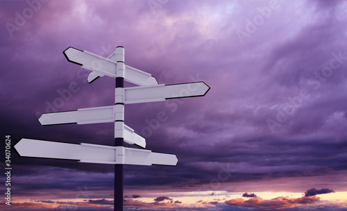 Image of blank signpost over dramatic sky