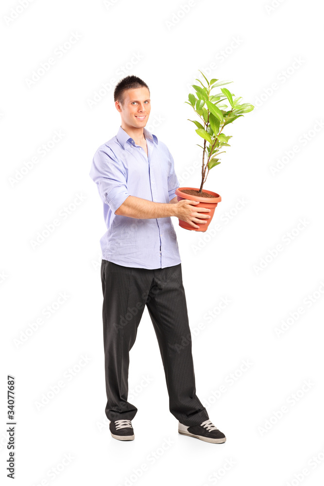 Happy young man holding a pot with decoration plant Happy young man holding a pot with decoration plant