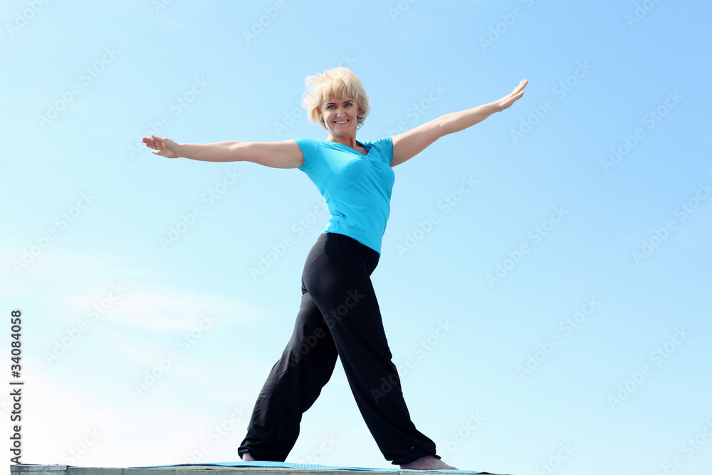 Fototapeta premium Portrait of a senior woman doing yoga