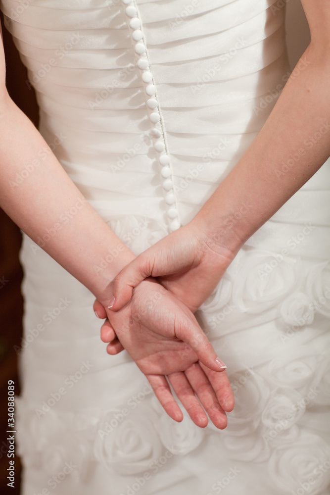 back of the wedding dress and hands back of the wedding dress and hands