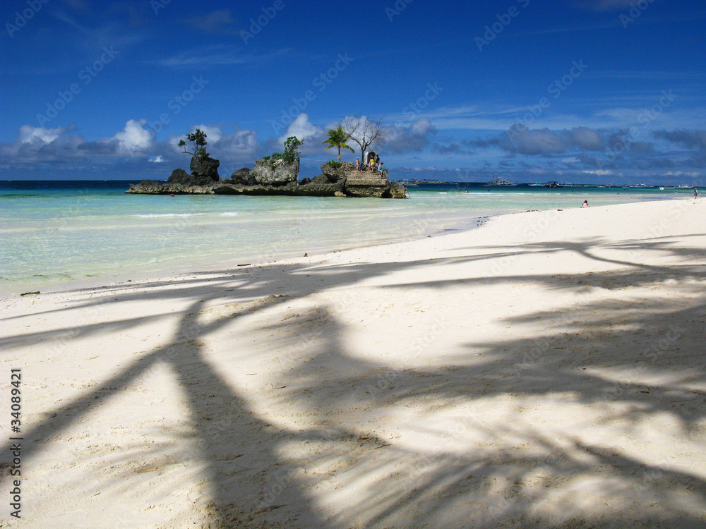 Lovely palm tree shadows on white sand beach