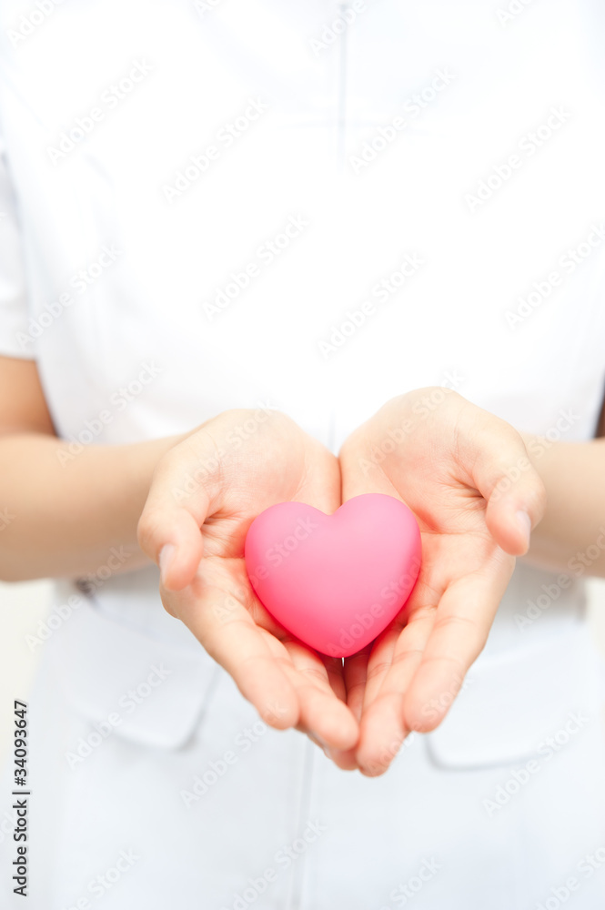 a nurse holding a symbol of heart a nurse holding a symbol of heart