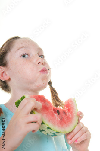 Valokuva Girl spitting out watermelon seed