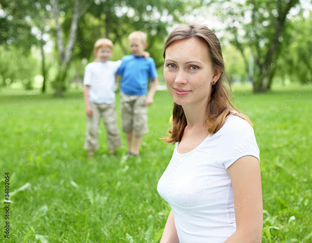 Fototapeta premium Portrait of mother with two sons on the background